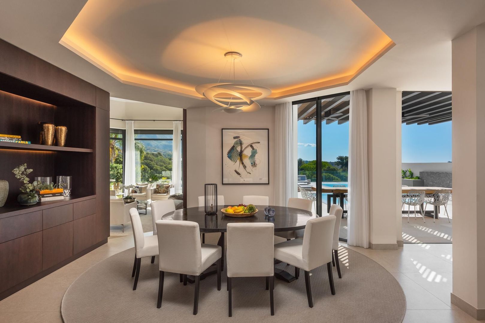 Seating area by the pool with pergola shadows