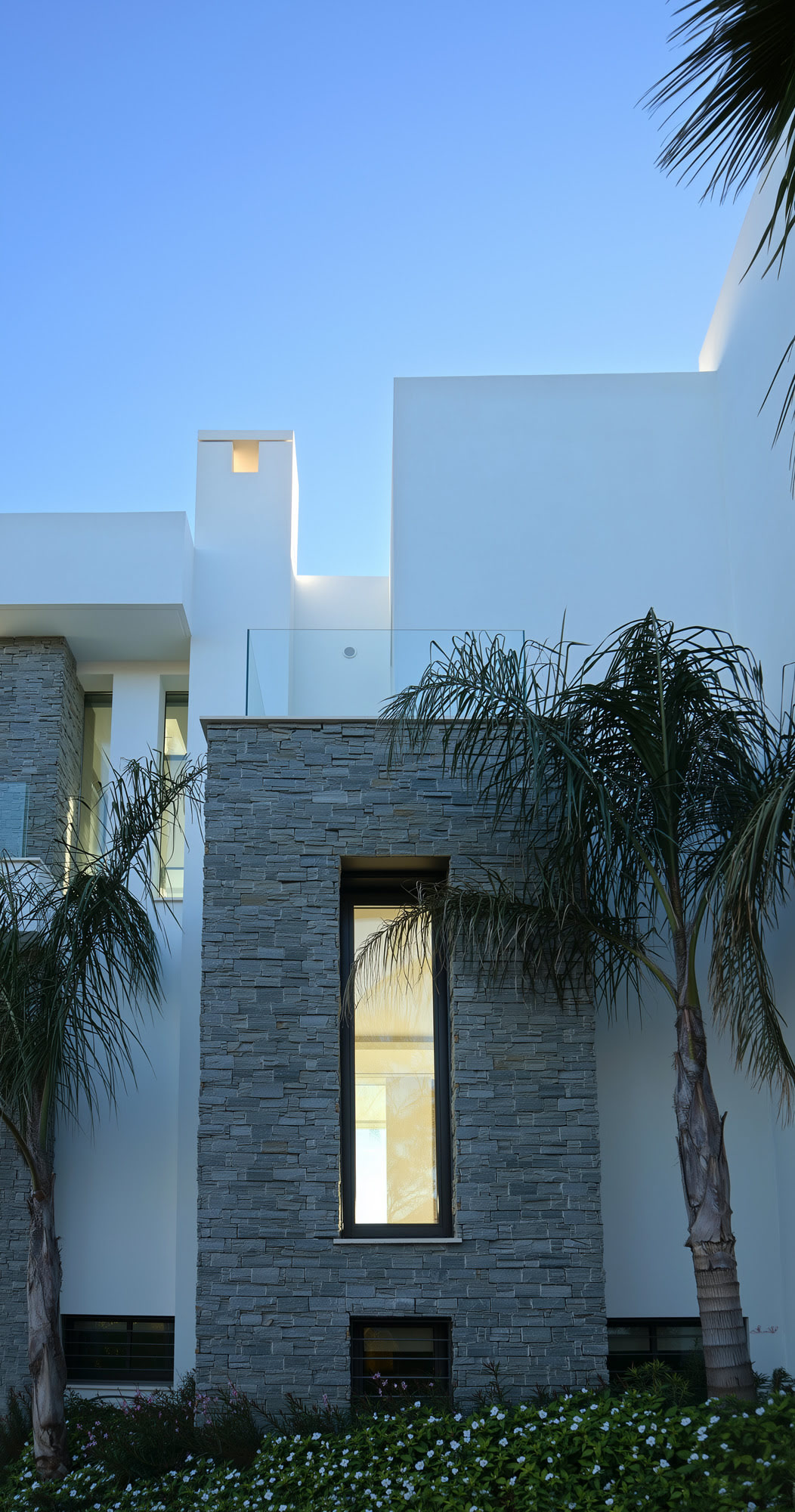 Double-height space with natural stone texture