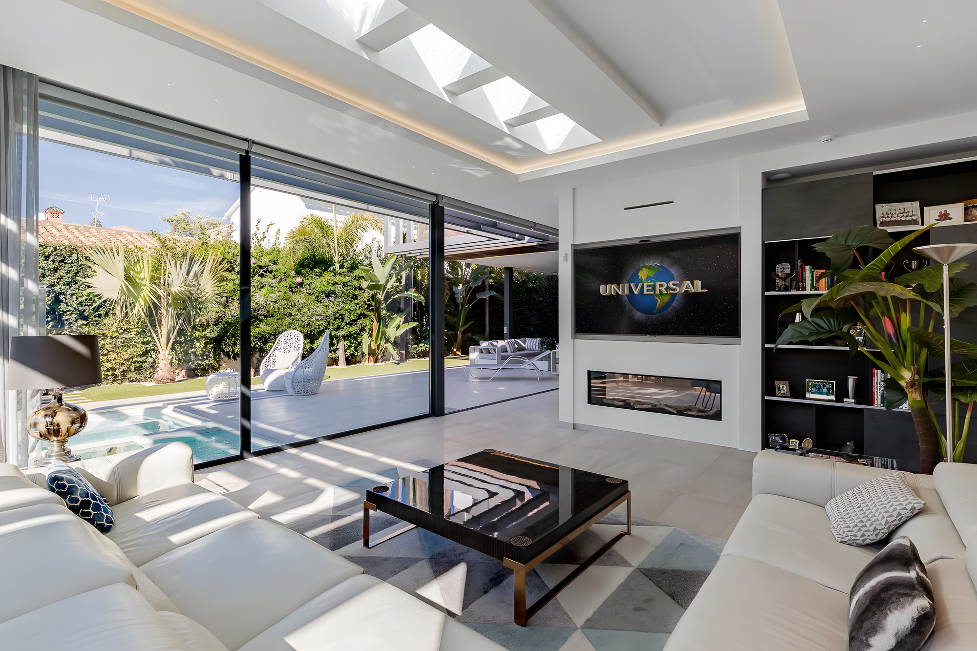 Dining space surrounded by nature through glass walls