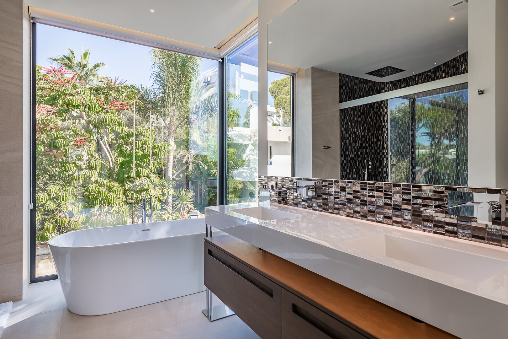 Lounge interior with full glass exposure to garden