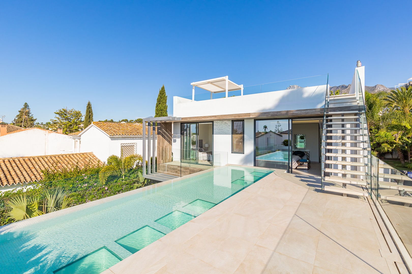 Minimalist white volumes anchored by black steel columns