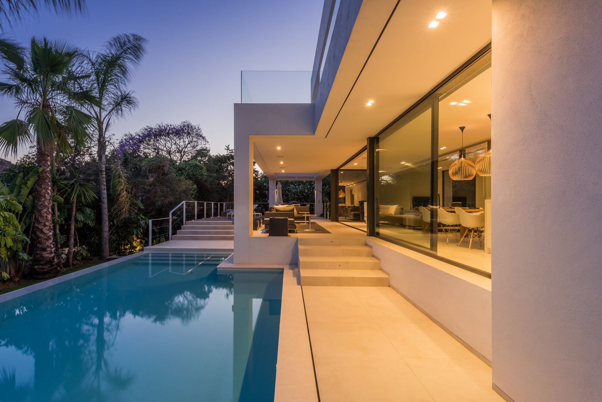 Open-plan living area connected to exterior through glass walls