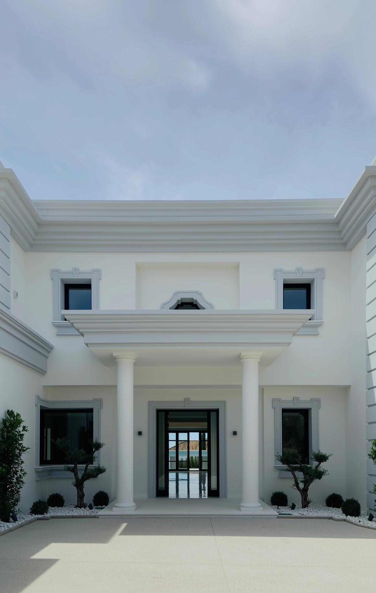 Wide staircase leading to main terrace with pillars