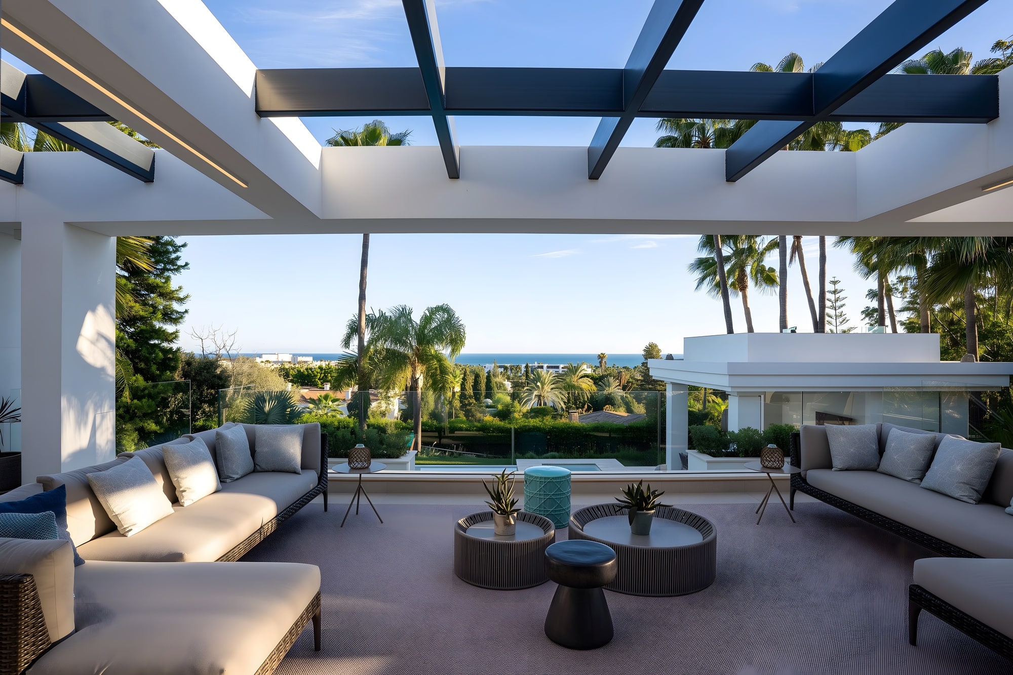 Terrace with sea views framed by palm trees and minimalist beams