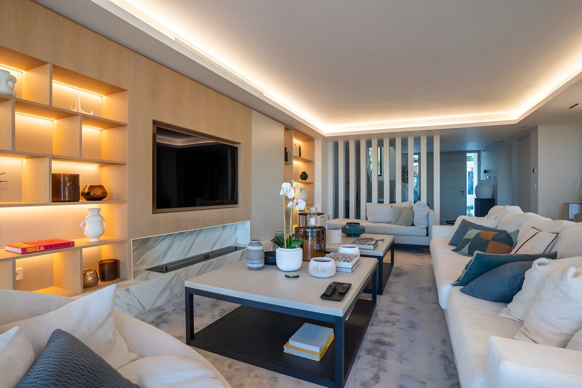 Infinity pool surrounded by white architecture and tropical gardens