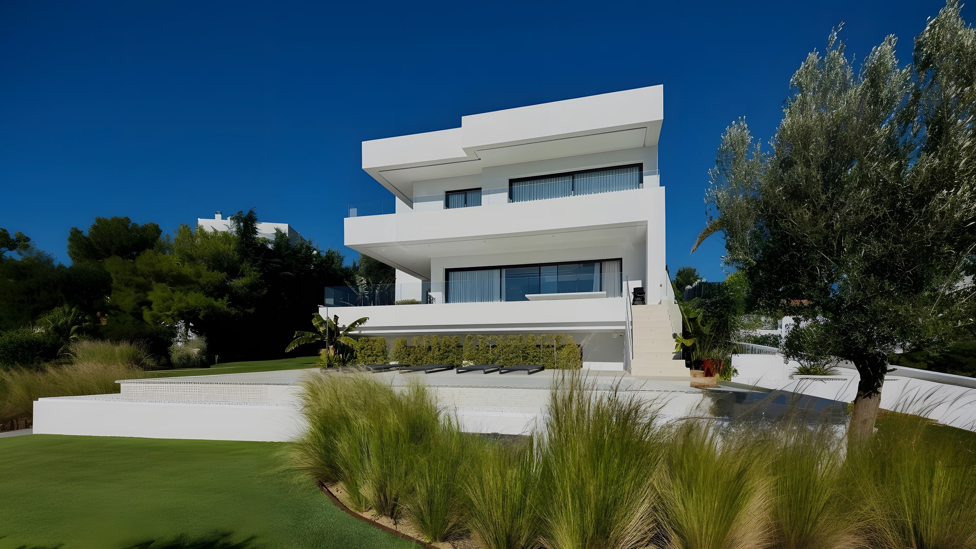 Front view of VILLA SALVADOR framed by Mediterranean landscaping