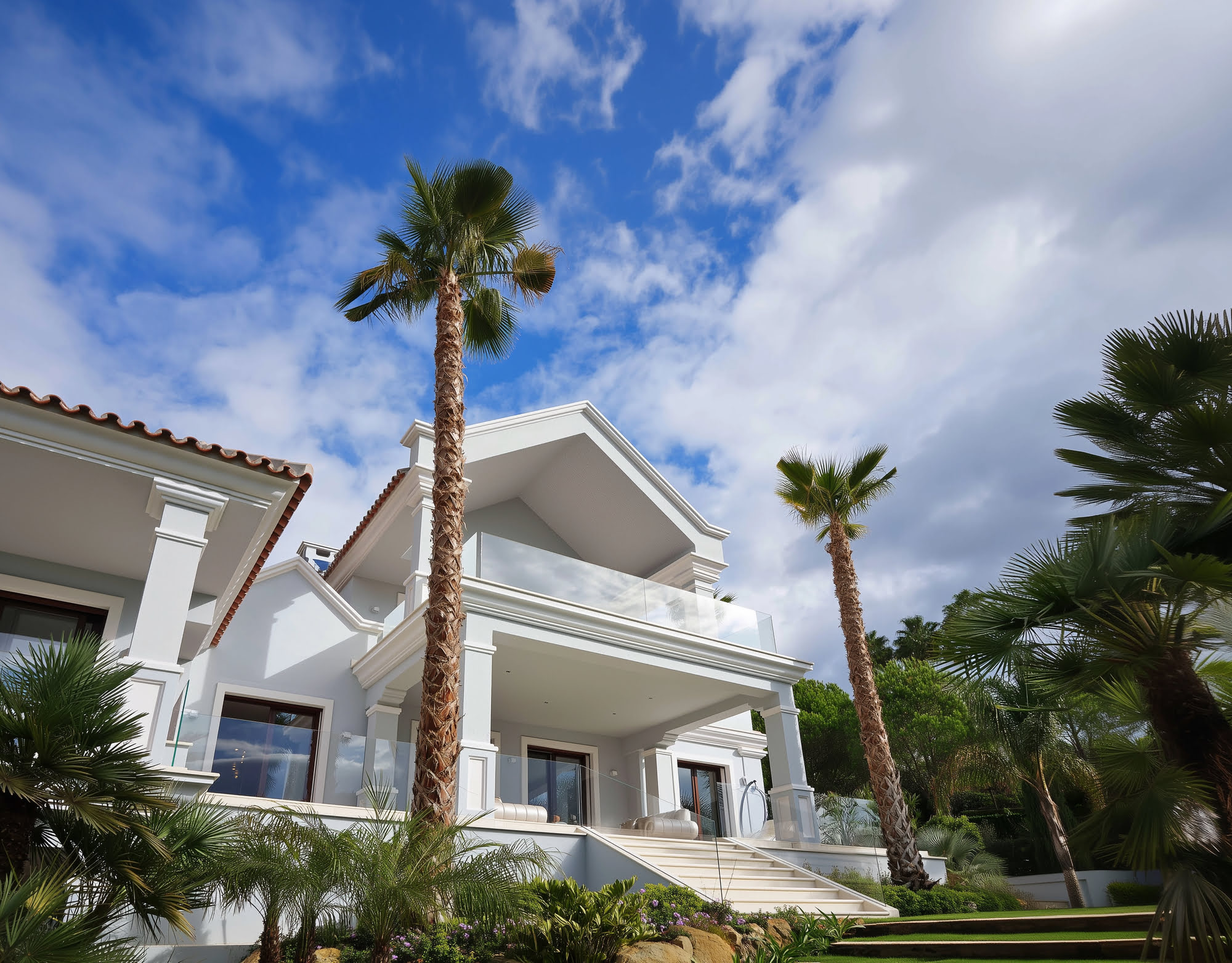 Stone steps leading through tropical garden toward villa