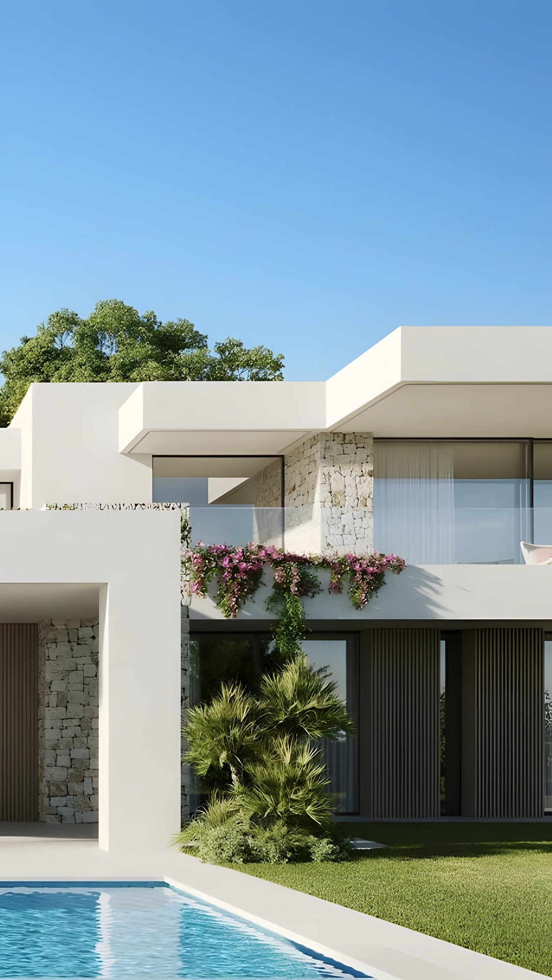 Sunset reflecting on pool beside stone-clad facade