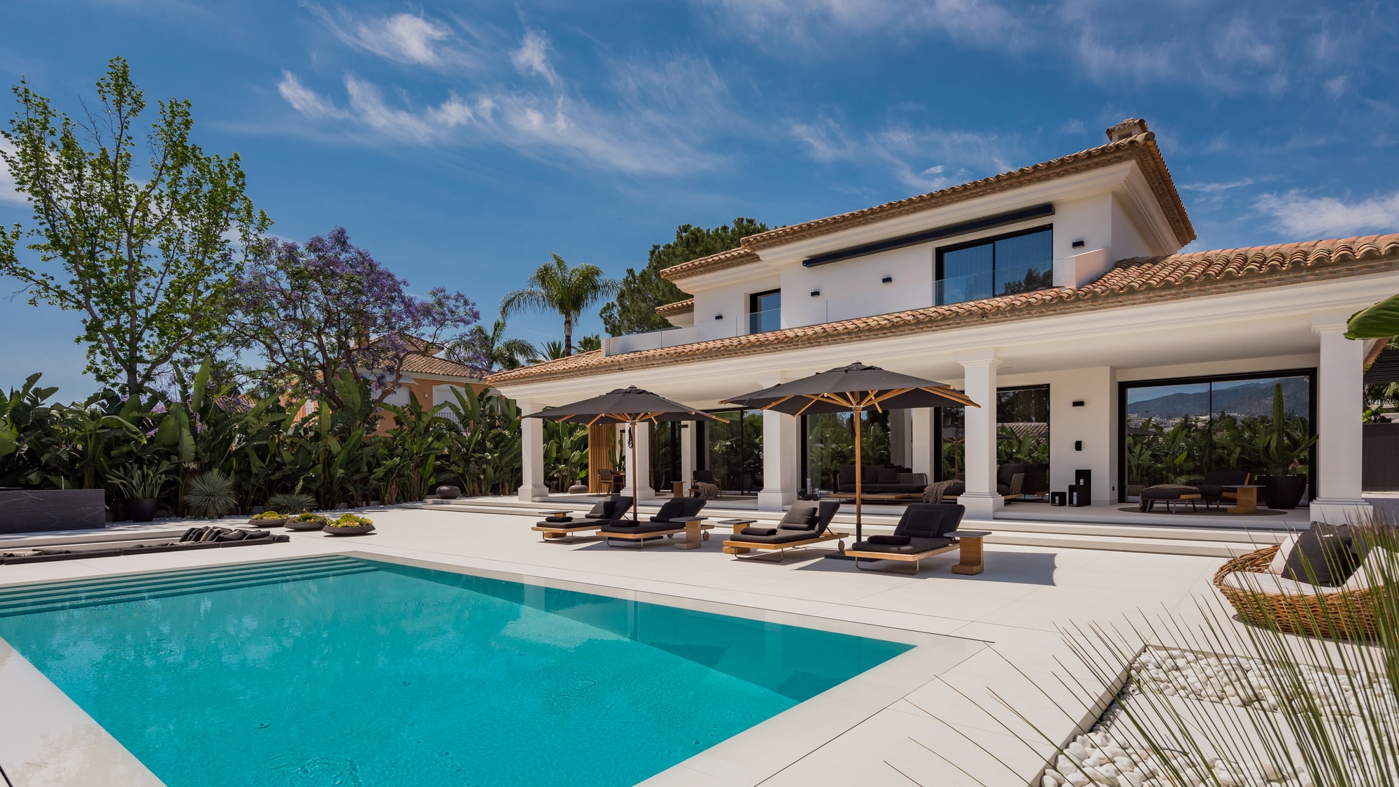 Frontal entrance of VILLA ZARINA surrounded by olive trees and soft lighting