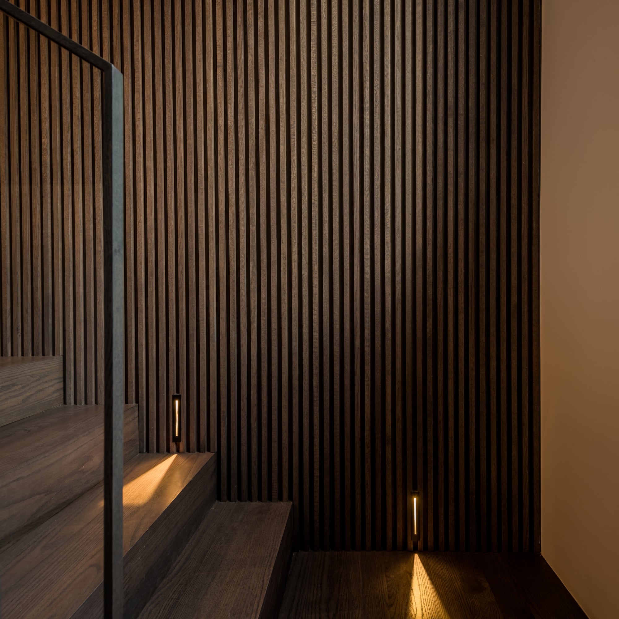 Guest bedroom with warm lighting and organic materials