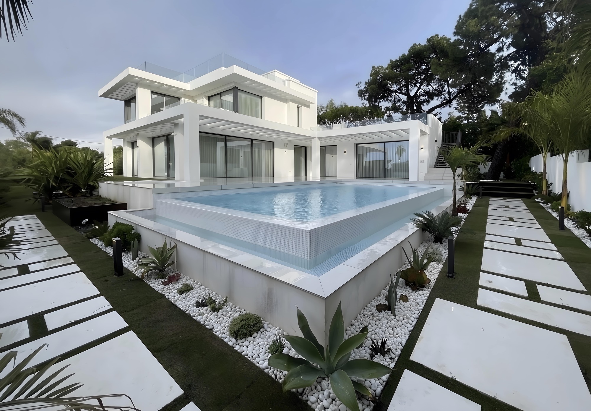 INÉS – minimalist white cube villa with water feature and garden